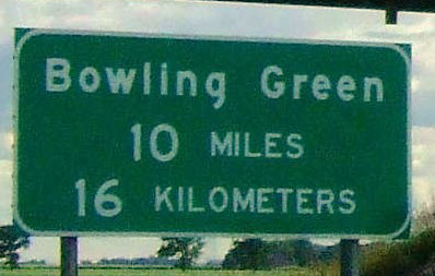 Distance sign with 10 miles 16 kilometers